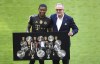 Bayern's David Alaba, left, poses with Bayern Munich CEO Karl Heinz Rummenigge prior to the start of the Bundesliga soccer match between Bayern Munich and FC Augsburg at the Allianz Arena stadium in Munich, Germany, Saturday, May 22, 2021. (AP Photo/Matthias Schrader, Pool)