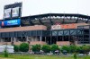 Pedestrians pass CitiField after a baseball game between the Atlanta Braves and the New York Mets was postponed due to inclement weather Friday, May 28, 2021, in New York. (AP Photo/Frank Franklin II)