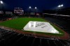 A tarp covers the infield during a rain delay before a baseball game between the Baltimore Orioles and the Chicago White Sox in Chicago, Friday, May 28, 2021. (AP Photo/Nam Y. Huh)