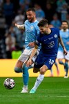 Manchester City's Kyle Walker, left, fights for the ball with Chelsea's Christian Pulisic during the Champions League final soccer match between Manchester City and Chelsea at the Dragao Stadium in Porto, Portugal, Saturday, May 29, 2021. (Pierre Philippe Marcou/Pool via AP)