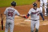 Minnesota Twins' Josh Donaldson (20) celebrates scoring against the Detroit Tigers with Max Kepler (26) in the ninth inning of a baseball game in Detroit, Saturday, May 8, 2021. (AP Photo/Paul Sancya)