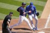 Minnesota Twins' Mitch Garver, center left, scores on a passed ball off Kansas City Royals pitcher Carlos Hernandez, right, in the fourth inning of a baseball game, Saturday, May 29, 2021, in Minneapolis. (AP Photo/Jim Mone)