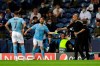 Manchester City manager Pep Guardiola hands over the captains armband to Bernardo Silva to pass on to Manchester City's Raheem Sterling after Kevin De Bruyne is substituted during the Champions League final soccer match between Manchester City and Chelsea at the Dragao Stadium in Porto, Portugal, Saturday, May 29, 2021. (AP Photo/Manu Fernandez, Pool)