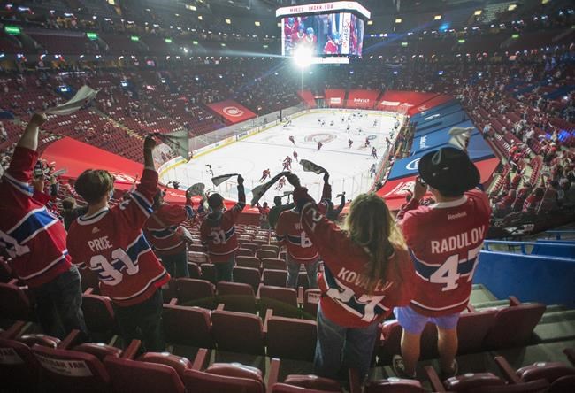 Fans watch the warm-up before Game 6 between the Toronto Maple Leafs and the Montreal Canadiens in NHL playoff hockey action Saturday, May 29, 2021 in Montreal. Quebec's easing of COVID-19 restrictions will allow 2,500 fans to attend the game for the first time in fourteen months. THE CANADIAN PRESS/Ryan Remiorz