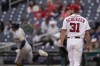 Washington Nationals starting pitcher Max Scherzer (31) looks on as Milwaukee Brewers' Avisail Garcia, left, runs the bases after hitting a two-run home run off him during the first inning of a baseball game, Sunday, May 30, 2021, in Washington. Brewers' Christian Yelich scored on the home run. (AP Photo/Julio Cortez)