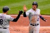 Colorado Rockies' Yonathan Daza (2) celebrate with teammate Joshua Fuentes after scoring on a triple by Charlie Blackmon during the fourth inning of a baseball game against the Pittsburgh Pirates in Pittsburgh, Sunday, May 30, 2021. (AP Photo/Gene J. Puskar)