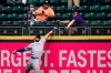 Texas Rangers right fielder Joey Gallo and a fan compete for the home run ball of Seattle Mariners' Kyle Seager in the fifth inning of a baseball game Sunday, May 30, 2021, in Seattle. (AP Photo/Elaine Thompson)
