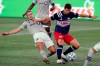 Montreal Impact's Samuel Piette, left, grapples with New England Revolution's Matthew Polster, right, during the second half of an MLS soccer match, Wednesday, Sept. 23, 2020, in Foxborough, Mass. THE CANADIAN PRESS/AP/Steven Senne