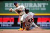 Milwaukee Brewers' Kolten Wong, left, forces Detroit Tigers' Jeimer Candelario out at second base as he turns a double play during the sixth inning of a baseball game Monday, May 31, 2021, in Milwaukee. (AP Photo/Aaron Gash)