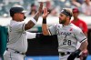 Chicago White Sox's Leury Garcia, right, and Yermin Mercedes celebrate after both score in the second inning of the first baseball game of a doubleheader against the Cleveland Indians, Monday, May 31, 2021, in Cleveland. (AP Photo/Tony Dejak)