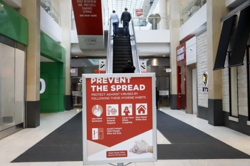 Shoppers take an escalator in an empty shopping mall in Calgary, Alta., Wednesday, March 18, 2020, amid a worldwide COVID-19 pandemic. Albertans will now be able to book appointments at barber shops, hair salons, and other personal wellness services starting today. THE CANADIAN PRESS/Jeff McIntosh