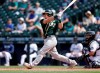 Oakland Athletic's Sean Murphy hits an RBI-double to tie the the baseball game against the Seattle Mariners during the eighth inning, Monday, May 31, 2021, in Seattle. (AP Photo/John Froschauer)