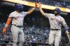 New York Mets' Dominic Smith and Jose Peraza (18) celebrate after scoring runs against the Arizona Diamondbacks on ball hit by Pete Alonzo in the third inning during a baseball game, Monday, May 31, 2021, in Phoenix. (AP Photo/Rick Scuteri)