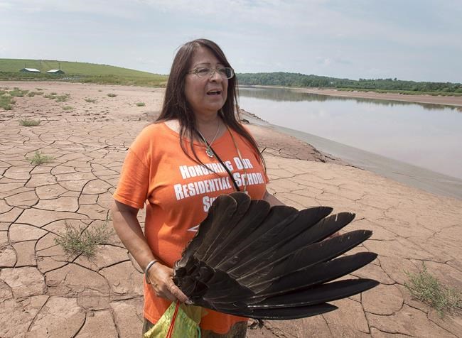 Mi'kmaq activist Dorene Bernard stands on the shores of the Shubenacadie River, a 72-kilometre tidal river that cuts through the middle of Nova Scotia and flows into the Bay of Fundy, in Fort Ellis, N.S. on July 31, 2018. Bernard, a survivor of the largest residential school in the Maritimes, says the search will continue for unmarked graves at the site of the former Shubenacadie Indian Residential school north of Halifax. THE CANADIAN PRESS/Andrew Vaughan