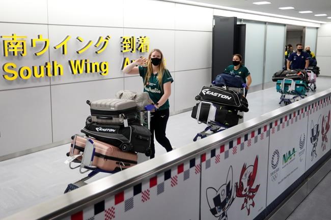 Members of Australia's Olympic softball squad, the first national team to come to Japan for pre-Olympic training camp since the Tokyo 2020 Olympic Games were postponed to 2021 due to the coronavirus disease (COVID-19) outbreak, arrive at Narita international airport in Narita, east of Tokyo, Japan Tuesday, June 1, 2021. (Issei Kato/Pool Photo via AP)