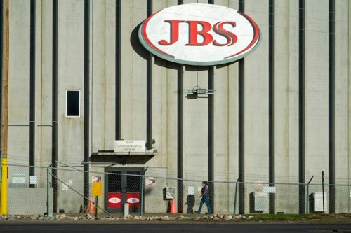 FILE - In this Oct. 12, 2020 file photo, a worker heads into the JBS meatpacking plant in Greeley, Colo. A weekend ransomware attack on the world’s largest meat company is disrupting production around the world just weeks after a similar incident shut down a U.S. oil pipeline. The White House confirms that Brazil-based meat processor JBS SA notified the U.S. government Sunday, May 30, 2021, of a ransom demand from a criminal organization likely based in Russia. (AP Photo/David Zalubowski, File)