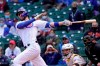 FILE - Chicago Cubs' Kris Bryant watches his hit during a baseball game against the Pittsburgh Pirates in Chicago, in this May 7, 2021, file photo. Bryant's versatility, while producing offensive numbers that belong alongside his NL MVP season in 2016, is a big reason why Chicago is on top of the NL Central once again, helping the Cubs go on a 21-9 run while dealing with a rash of injuries. (AP Photo/Charles Rex Arbogast, File)