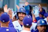 Los Angeles Dodgers' Cody Bellinger, center, smiles in the dugout after his grand slam against the St. Louis Cardinals during the first inning of a baseball game Wednesday, June 2, 2021, in Los Angeles. (AP Photo/Marcio Jose Sanchez)