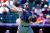 Texas Rangers catcher Jose Trevino throws to first base to put out Colorado Rockies Raimel Tapia after bunting in the third inning of a baseball game Thursday, June 3, 2021, in Denver. (AP Photo/David Zalubowski)