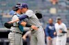 Tampa Bay Rays catcher Mike Zunino, left, congratulates Rays starting pitcher Ryan Yarbrough, center, with an embrace after Yarbrough pitched a complete baseball game in the Rays 9-2 victory over the New York Yankees, Thursday, June 3, 2021, at Yankee Stadium in New York. (AP Photo/Kathy Willens)