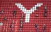 Fans sit on the tribune as they wait the start of the Bundesliga soccer match between Bayern Munich and FC Augsburg at the Allianz Arena stadium in Munich, Germany, Saturday, May 22, 2021. (AP Photo/Matthias Schrader, Pool)