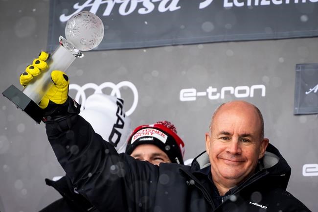 FILE - In this Sunday, March 21, 2021 file photo Johan Eliasch, Chairman of the Management Board of the HEAD group celebrates on the podium at the FIS Alpine Skiing World Cup finals, in Parpan-Lenzerheide, Switzerland. Billionaire businessman Johan Eliasch has been elected president of the International Ski Federation. The CEO of ski and tennis brand Head was one of four candidates and follows long time president Gian Franco Kasper. (Jean-Christophe Bott/Keystone via AP, file)