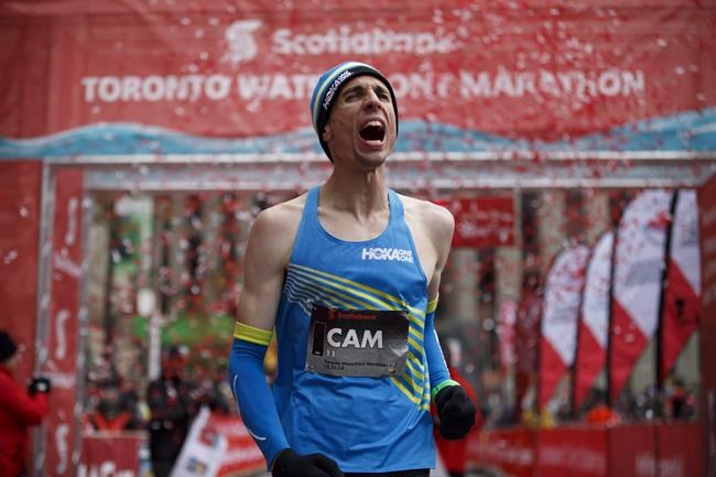 Canadian Cam Levins reacts as he crosses the finish line of the Toronto Scotiabank Waterfront Marathon in Toronto on Sunday, Oct. 21, 2018. THE CANADIAN PRESS/Cole Burston