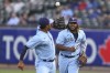 Toronto Blue Jays' Vladimir Guerrero Jr. (27) tosses the ball to Marcus Semien after making a catch for an out on Houston Astros' Carlos Correa during the third inning of a baseball game in Buffalo, N.Y., Friday, June 4, 2021. (AP Photo/Joshua Bessex)
