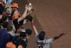 Cleveland Indians left fielder Eddie Rosario, right, goes up to try to catch a two-run home run by Baltimore Orioles designated hitter Ryan Mountcastle off relief pitcher Bryan Shaw during the seventh inning of a baseball game, Friday, June 4, 2021, in Baltimore. Orioles' Freddy Galvis scored on the home run. Umpires reviewed the play for a possible fan interference, but ruled the play a home run. (AP Photo/Julio Cortez)