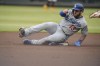 Los Angeles Dodgers' Max Muncy slides into second base being after being forced out on a double play hit into by Justin Turner during the first inning of a baseball game against the Atlanta Braves on Friday, June 4, 2021, in Atlanta. (AP Photo/Brynn Anderson)