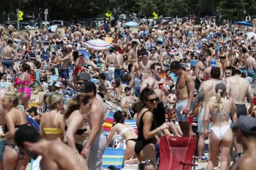 Crowds gather on L Street Beach, Saturday, June 5, 2021, in the South Boston neighborhood of Boston. New England is giving the rest of the country a possible glimpse into the future if more Americans get vaccinated. The six-state region has among the highest vaccination rates in the U.S. and is seeing sustained drops in COVID-19 cases, hospitalizations and deaths.  (AP Photo/Michael Dwyer)