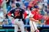 Washington Nationals' Juan Soto, left, reacts past Philadelphia Phillies catcher J.T. Realmuto after striking out against pitcher Connor Brogdon to end a baseball game, Saturday, June 5, 2021, in Philadelphia. (AP Photo/Matt Slocum)