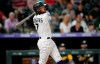 Colorado Rockies pinch hitter Brendan Rodgers follows the fight of his two-run home run off Oakland Athletics starting pitcher Jesus Luzardo in the seventh inning of a baseball game Saturday, June 5, 2021, in Denver. (AP Photo/David Zalubowski)