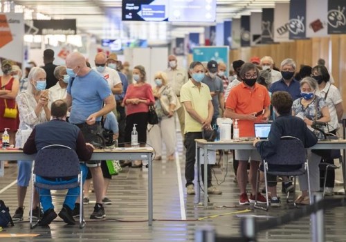 Some people eligible for a second COVID-19 vaccination shot wait in line at the Palais des congres vaccination site in Montreal, Sunday, June 6, 2021. THE CANADIAN PRESS/Graham Hughes