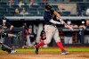 Boston Red Sox's Xander Bogaerts hits a two-run single during the 10th inning of a baseball game against the New York Yankees, Sunday, June 6, 2021, at Yankee Stadium in New York. Yankees catcher Gary Sanchez (24) is behind the plate. (AP Photo/Kathy Willens)