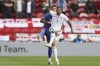 England's Ben White, left, challenges for the ball with Romania's Denis ALibec during the international friendly soccer match between England and Romania in Middlesbrough, England, Sunday, June 6, 2021. (AP Photo/Scott Heppell, Pool)