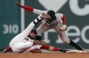 Miami Marlins' Jazz Chisholm Jr., right, tags out Boston Red Sox's Marwin Gonzalez who was trying to advance to second base after hitting a line drive during the fifth inning of a baseball game, Monday, June 7, 2021, in Boston. (AP Photo/Michael Dwyer)