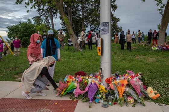 Mourners leave flowers at the site where a family of five was hit by a driver, in London, Ont., Monday, June 7, 2021. A vigil is scheduled for tonight at the local mosque of the family struck and killed by a driver in an attack London, Ont., police said was intentional. THE CANADIAN PRESS/Brett Gundlock