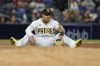 San Diego Padres third baseman Manny Machado looks on after diving and missing a ball hit for a single by Chicago Cubs' Eric Sogard during the seventh inning of a baseball game Monday, June 7, 2021, in San Diego. (AP Photo/Gregory Bull)