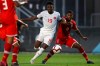 Canada's Alphonso Davies (19) breaks past Cayman Island defender Cameron Gray during the second half of a World Cup 2022 Group B qualifying soccer match Monday, March 29, 2021, in Bradenton, Fla.&nbsp; THE CANADIAN PRESS/AP-Mike Carlson