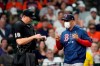 Boston Red Sox manager Alex Cora, right, argues strike calls with home plate umpire Lance Barrett during the sixth inning of a baseball game Thursday, June 3, 2021, in Houston. (AP Photo/David J. Phillip)