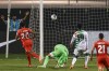 Canada's Jonathan David (20) scores past Suriname's Warner Hahn, second from left, during the second half of a World Cup 2022 Group B qualifying soccer match Tuesday, June 8, 2021, in Bridgeview, Ill. (AP Photo/Kamil Krzaczynski)