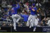 Chicago Cubs' Patrick Wisdom, right, celebrates with third base coach Willie Harris after hitting a two-run home run during the sixth inning of the team's baseball game against the San Diego Padres, Tuesday, June 8, 2021, in San Diego. (AP Photo/Gregory Bull)