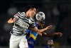 South Korea's Kim Young-gwon, left, fights for the ball against Sri Lanka's Ahmed Waseem during their Asian zone Group H qualifying soccer match for the FIFA World Cup Qatar 2022 at Goyang stadium in Goyang, South Korea, Wednesday, June 9, 2021. (AP Photo/Lee Jin-man)