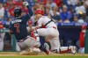 Philadelphia Phillies catcher J.T. Realmuto, right, forces out Atlanta Braves' Dansby Swanson during the second inning of a baseball game Wednesday, June 9, 2021, in Philadelphia. (AP Photo/Chris Szagola)