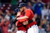 Boston Red Sox closer Matt Barnes, right, hugs catcher Christian Vazquez after the Red Sox's 12-8 victory over the Houston Astros in a baseball game at Fenway Park, Thursday, June 10, 2021, in Boston. (AP Photo/Elise Amendola)