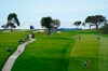 FILE - In this Jan. 31, 2021, file photo, Jon Rahm, lower right, of Spain, walks down with 13th fairway with his caddie, Adam Hayes, on the South Course during the final round of the Farmers Insurance Open golf tournament at Torrey Pines in San Diego. Rahm will return from self-isolation for a positive COVID-19 test in time for the U.S. Open at Torrey Pines on June 17-20. (AP Photo/Gregory Bull, File)