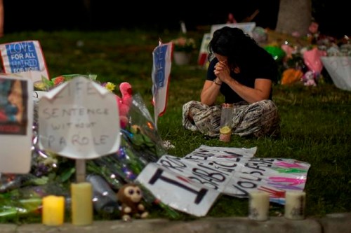 A woman sits and weeps at the scene of Sunday's hate-motivated vehicle attack in London, Ont. on Tuesday, June 8, 2021.&nbsp;Four members of a family in London, Ont., are set to be buried today. The public has been invited to help celebrate the lives of Talat Afzaal, 74, her son Salman Afzaal, 46, his wife Madiha Salman, 44, and their 15-year-old daughter Yumna Salman.THE CANADIAN PRESS/ Geoff Robins