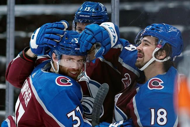 FILE - In this May, 12, 2021, file photo, Colorado Avalanche left wing J.T. Compher (37) is congratulated by teammates Valeri Nichushkin (13) and Alex Newhook (18) after scoring his third goal against the Los Angeles Kings during the second period of an NHL hockey game in Denver. Newhook went from playing in college to making an impact on his team at the most important time of the year. (AP Photo/Jack Dempsey, File)