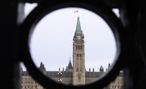 The Parliament Hill Peace Tower is framed in an iron fence on Wellington Street in Ottawa on Thursday, March 12, 2020. After weeks of virtual hearings and often heated debate, an extensively amended Bill C-10 will go back to the House of Commons for a final vote.THE CANADIAN PRESS/Sean Kilpatrick